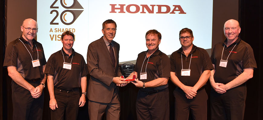 Honda executives pose for a picture as they receive an award