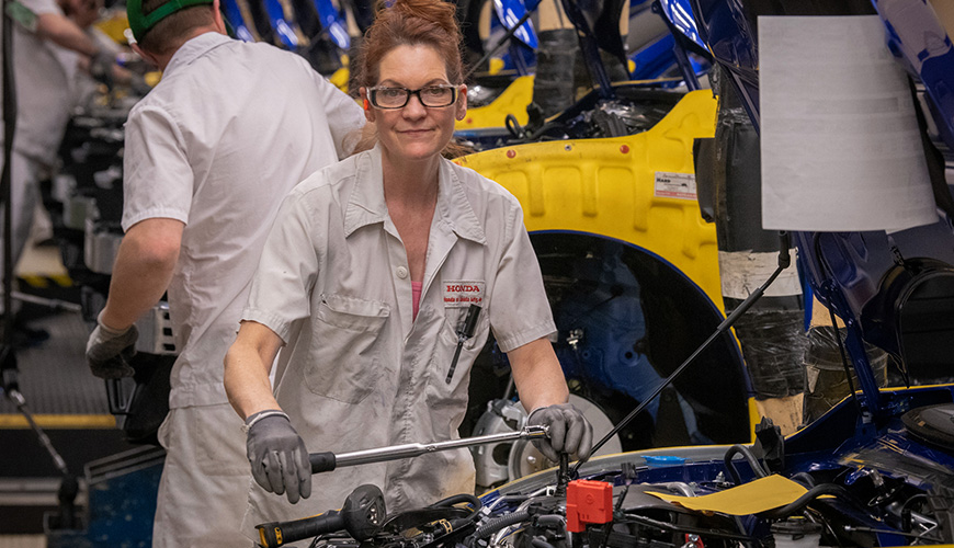 Female Honda of Canada Mfg. employee with wrench on final assembly