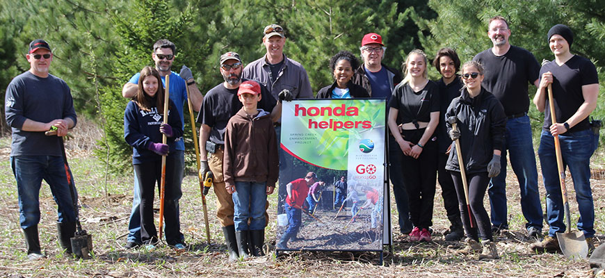 Honda Helpers in pose for a picture while planting trees